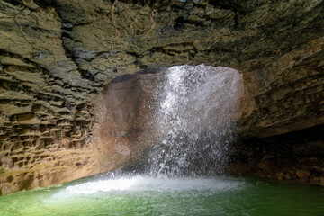 Picturesque Saltinsky underground waterfall in cave in nature park at Dagestan.