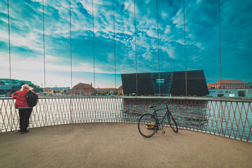 man on the bridge in Copenhagen, Black Diamond in the background