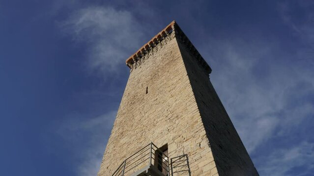 Running clouds over the tower - a timelapse in a characteristic Italian village during a windy day