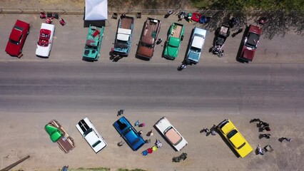 Aerial drone shot of car show on rural desert highway in small western town