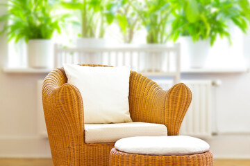 Customizable home decor concept: wicker armchair and ottoman poof with white cushions and throw pillow for mock up.