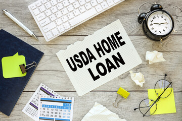 USDA HOME LOAN white keyboard and notepad with text on desktop