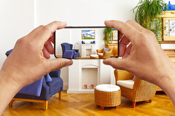 Augmented or mixed reality concept: hands holding smart phone with AR interior decoration app,...