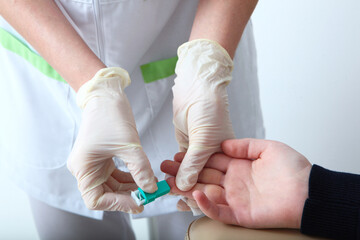 Blood is taken from the child's finger for analysis. Blood from the finger. Taking blood for...