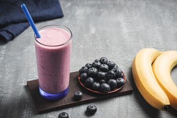 Blueberry and banana smoothie drink in a glass, healthy eating concept