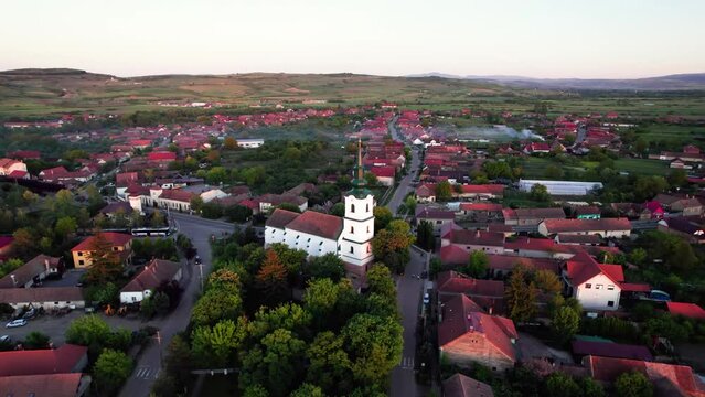 Aerial panorama of reformed protestant church in center of green village