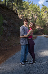 couple of tourists in love young guy and girl during a hike in nature on the weekend. Active lifestyle together, tenderness, first love