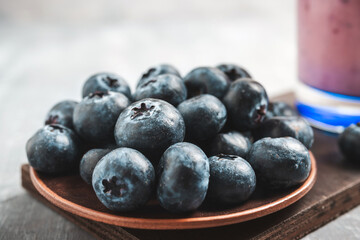 Fresh blueberries in a plate on a table, close up view