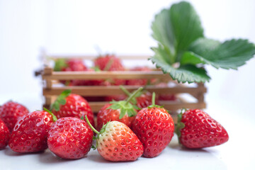 Closeup of fresh strawberries Isolated on white background, strawberries in wooden basket in blurred background
