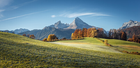 Fototapeta na wymiar Amazing nature scenery in mountain. Beautiful natural landscape in the summer morning. Mountain valley with fresh green grass and Watzmann Mountain ranges. Amazing nature Background. creative image