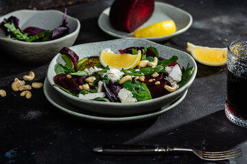 Salad with beets and goat cheese on a dark background