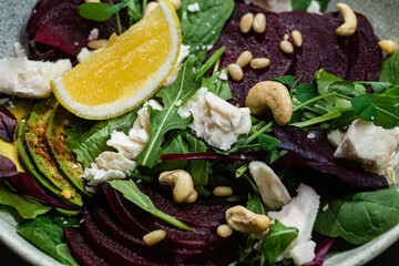 Salad with beets and goat cheese on a dark background