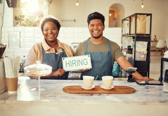 Portrait, collaboration and hiring sign by small business owners happy at coffee shop or cafe in...