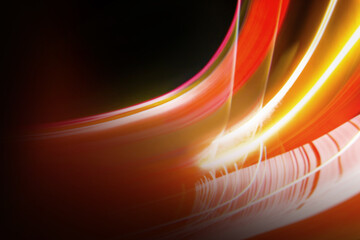 Abstract colorful background with red, white and yellow glowing lines of different thickness and curvature from city lights on a black background. The blur is intentional.	