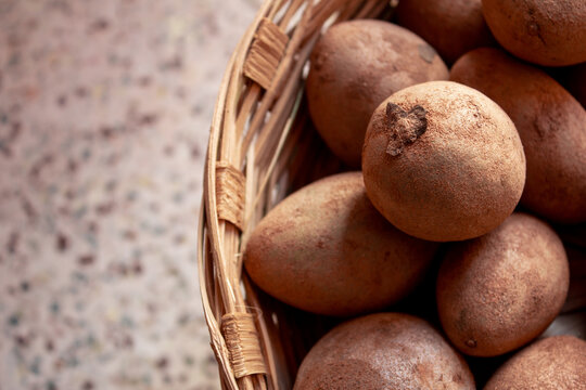 Freshly plucked Manilkara zapota, commonly known as sapodilla in a bunch