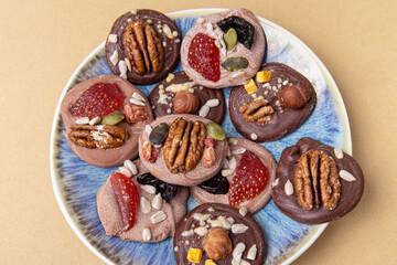 French sweets. Chocolate candies with berries and nuts. Chocolate mediants