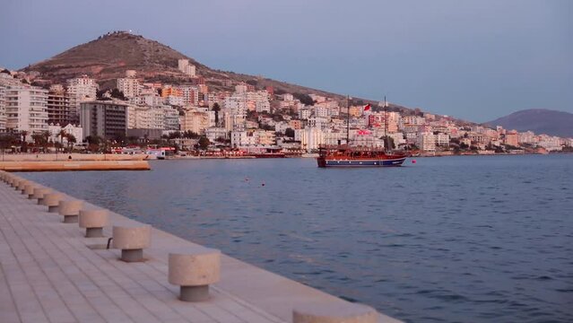Wonderful cityscape of Saranda port. Calm Ioninian seascape. Beautiful evening scene of Albania, Europe. Traveling concept background. Full HD video (High Definition)..