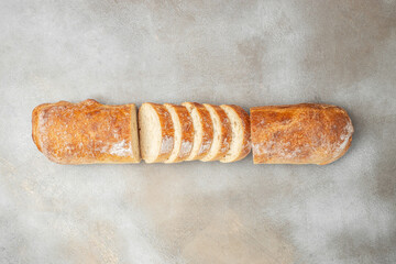 Italian ciabatta bread cut in slices on a light background. banner, menu, recipe place for text, top view