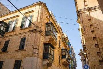Fototapeta na wymiar Traditional balconies wooden in a Valletta street - luxury mansions baroque style , Malta.