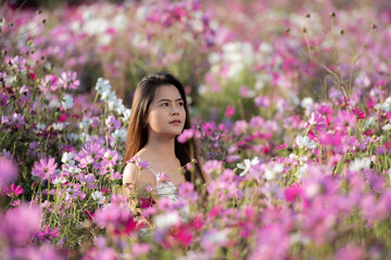 woman holding flowers in the garden. woman holding pink flowers.