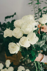 Small business flower shop florist hands preparing a bouquet