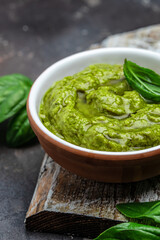 Homemade pesto sauce and ingredients, Traditional Italian pesto recipe for pasta on a dark background, vertical image. top view. place for text