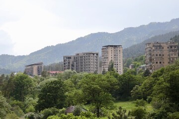 Fototapeta na wymiar residential silos in nature with mountains, Bordschomi, Georgia, Caucasus