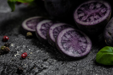 Raw purple sweet potato food . Fresh potatoes in an old sack on wooden background. Batata potato. vegan food ingredient. banner, menu, recipe place for text, top view