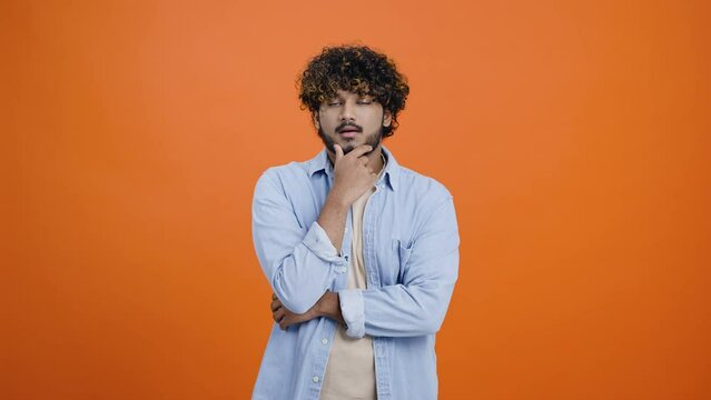 Upset Hindus man ponders difficult question rubbing chin