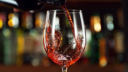 Detail of pouring red wine into glass. - obrazy, fototapety, plakaty