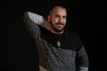 man posing stretching out. Black background studio photography. 