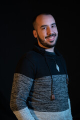 Granada, Spain; 01-12-2023: man posing smiling. Black background studio photography. 