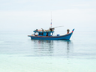 fishing boats between islands in the sea