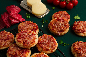 Mini pizzas, salami with mozzarella cheese, on the table, top view, no people,