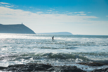 Naklejka premium surfer out at sea