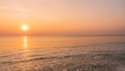 Obraz premium Sunset sky over sea in the morning with orange, red, pink sunrise 