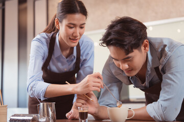 Before competing in the championship level coffee brewing competition, both of the baristas practice their coffee latte makeup techniques to become proficient.