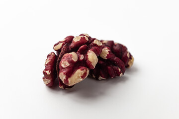 Red walnuts on a white background