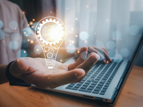 Concept of Ideas for presenting new ideas.Creative and inspiration.Innovative technology.Businessman holding light bulb and brain insideBusinessman holding light bulb and brain inside.