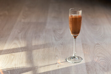  glass of  pink champagne and shadow