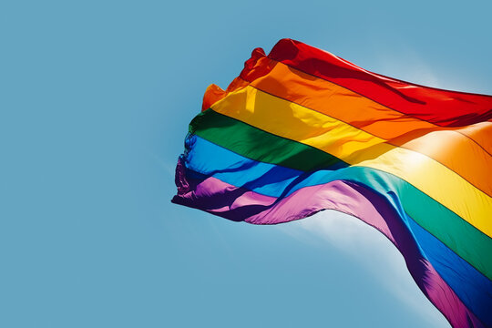 AI generated image of waving LGBT flag against blue sky