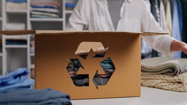 Recycling box, Happy young woman doing charity work Program participant Bright clothes In slow motion Responsible housewife waste sorting and sustainability recycling at home, climate change

