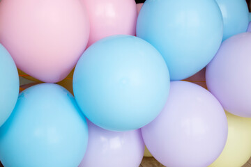 Pastel color pink blue and yellow balloons, party concept 