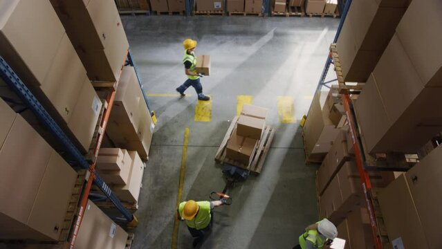 Top-Down View: In Warehouse People Working, Forklift Truck Operator Lifts Pallet with Cardboard Box. Logistics, Distribution Center with Products Ready for Global Shipment, Customer Delivery