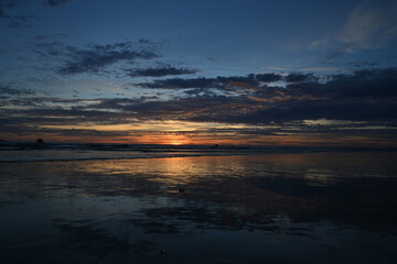 sunset under the clouds by the sea