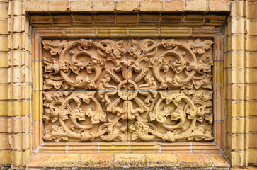 Historic exterior architectural detail with tendril ornamentation made of brick material, Old Barracks in the town of Neustrelitz, Mecklenburg- Western Pomerania, Germany, Europe.