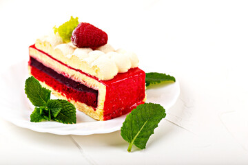 A piece of raspberry sponge cake with mint