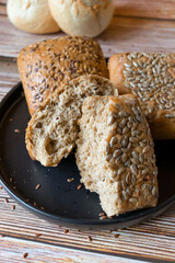 
buns with seeds on a daily table, on a rustic wooden background.