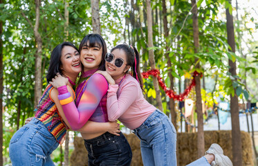 Naklejka premium Group of friends LGBTQ having fun together happy Thai transgender Asian woman LGBTQIA at music festival LGBT