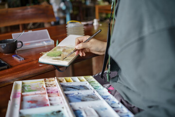 Student in classes at art studio. Hand holding artist brush mix color oil painting on palette art creativity and people concept 